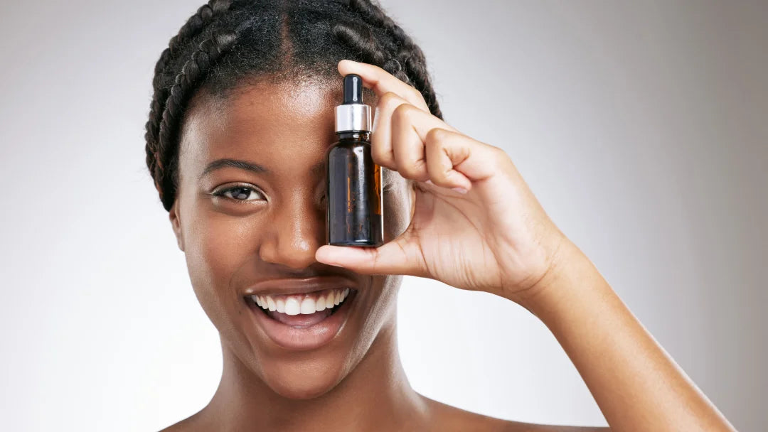 A woman showcasing a bottle of retinol oil, highlighting its skincare benefits for a youthful appearance.